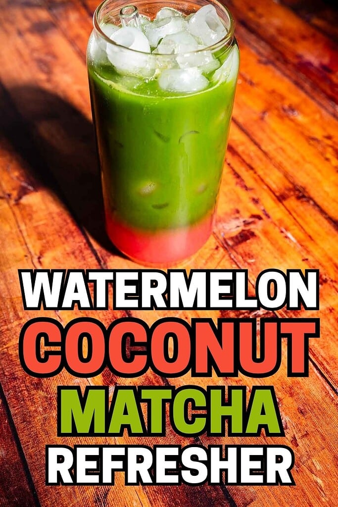 A glass filled with a layered iced drink in green and pink sits on a wooden surface. Text reads: "Watermelon Coconut Matcha Refresher.