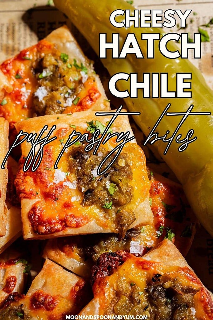 Squares of hatch chile puff pastry topped with melted cheese and green chile, arranged closely on a surface, with text reading “Cheesy Hatch Chile Puff Pastry Bites.”.