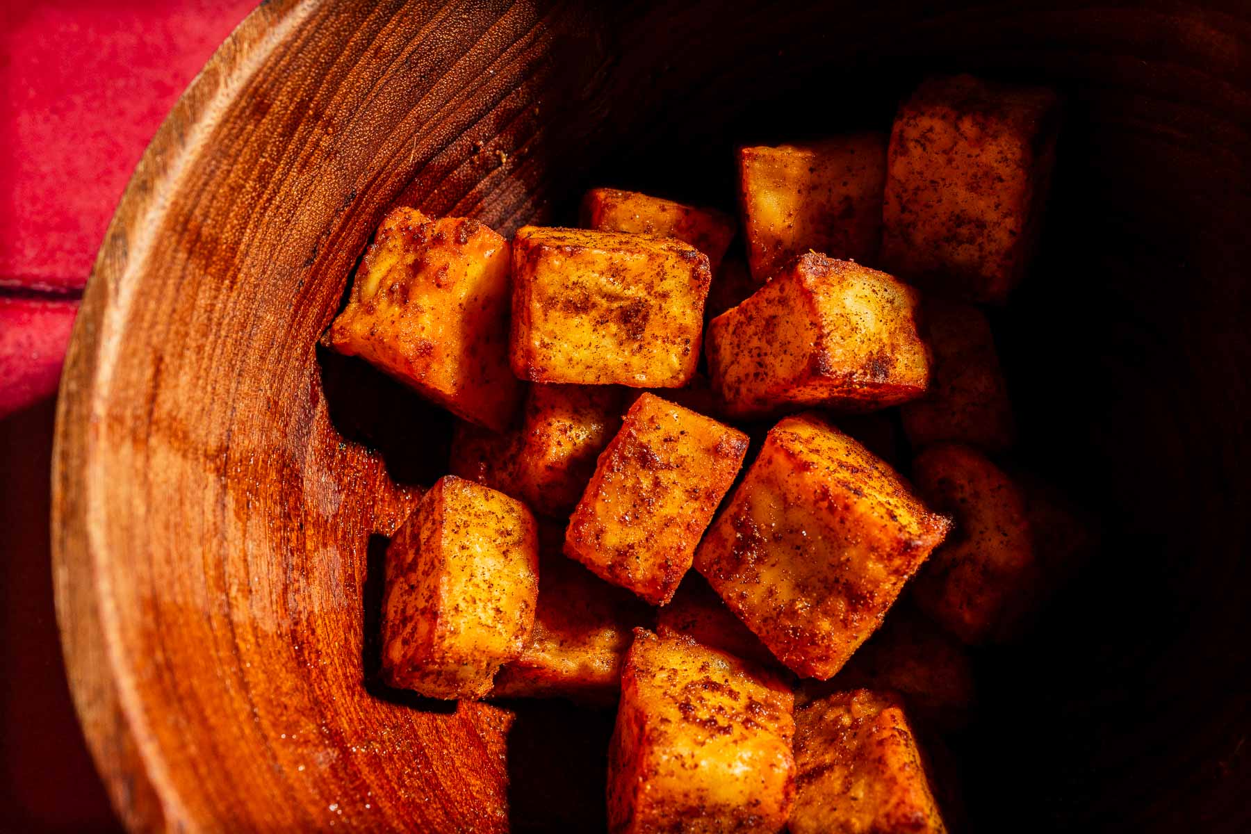 Seasoned, cubed air fryer tofu in a wooden bowl.